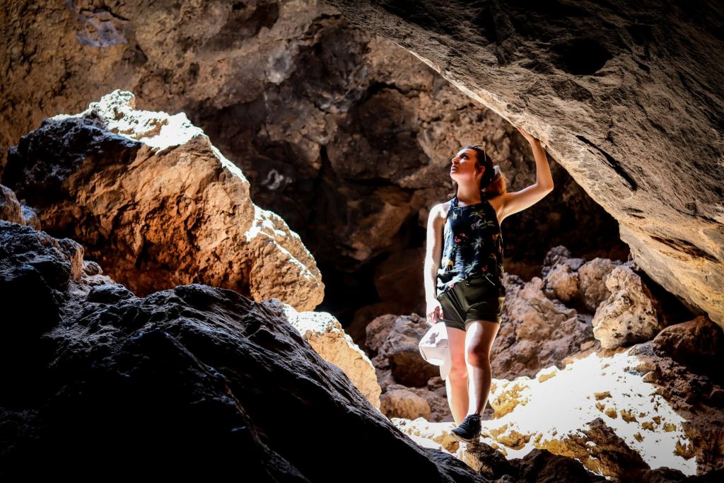 A woman exploring a cave