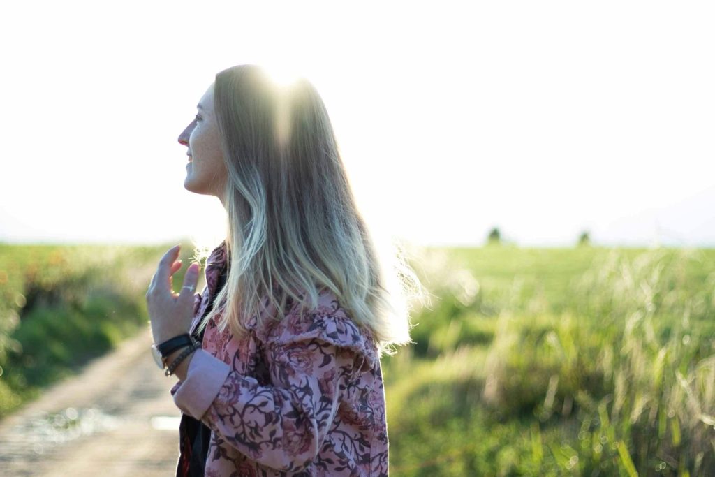 A woman walking in the countryside on a sunny day