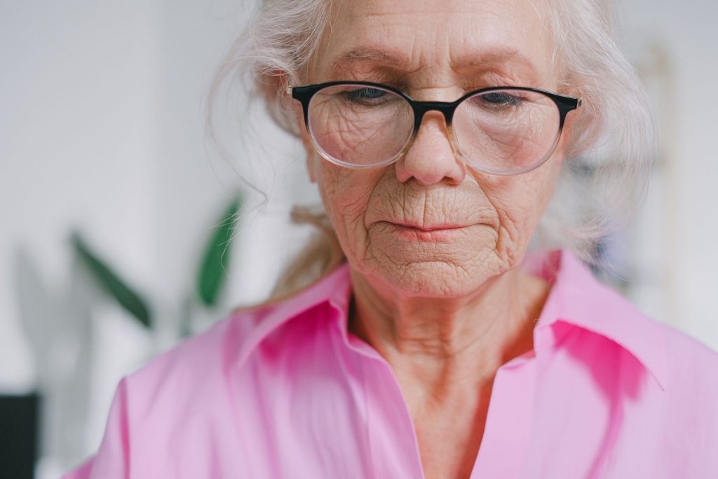 An elderly woman wearing glasses
