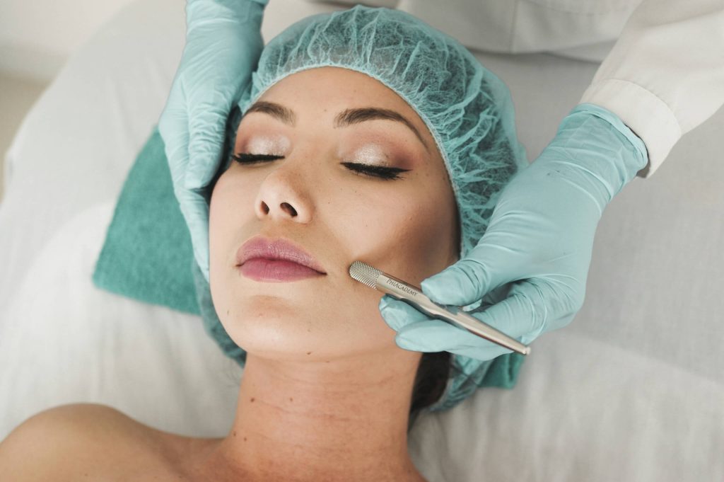 A woman receiving a facial treatment in a beauty salon