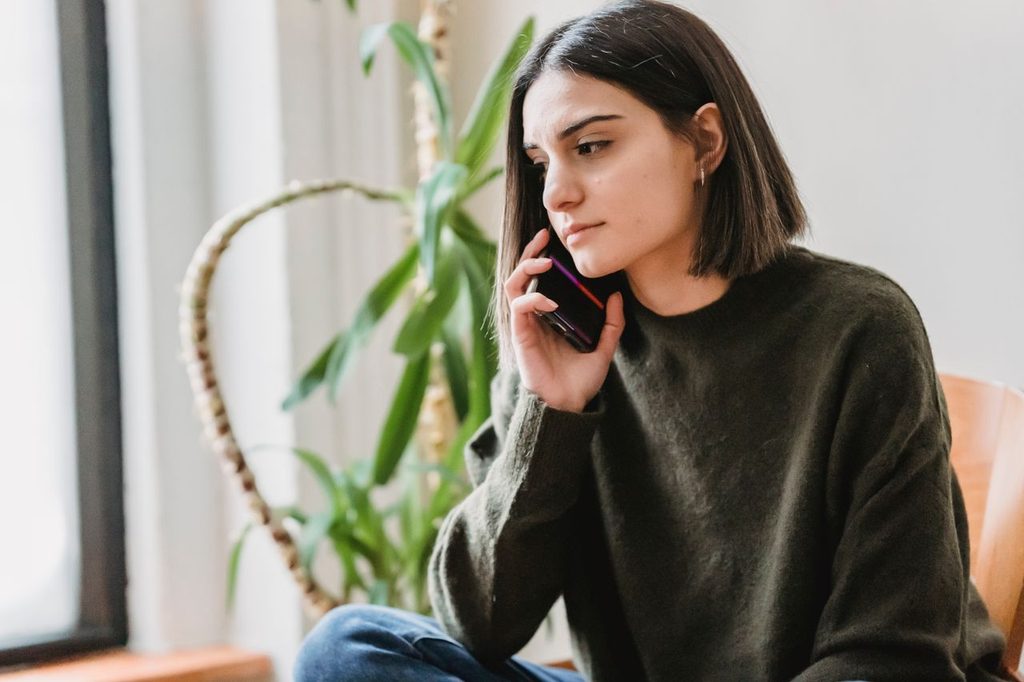 A woman talking on a mobile phone at home